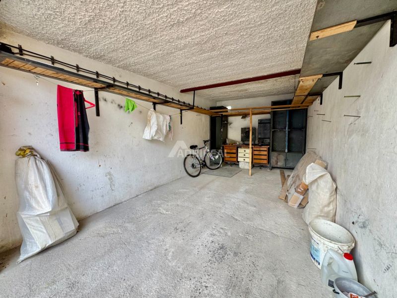 Garages in Detva with a bicycle, a shelf, and storage space.