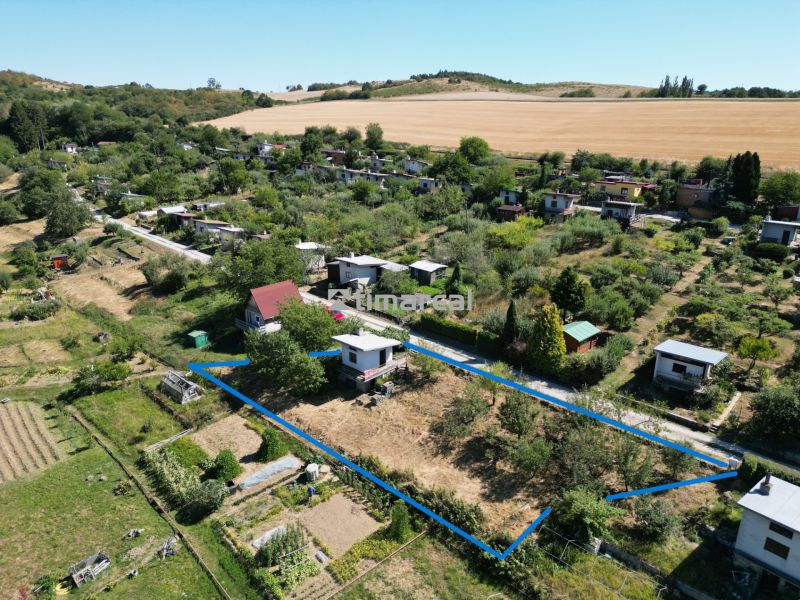 A view of the area with cottages in picturesque Myjava, surrounded by fields and gardens.