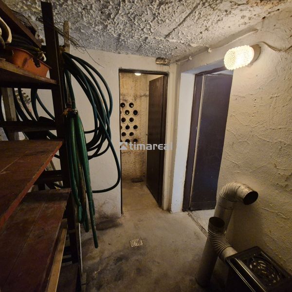 A storage space in a cabin with hoses and metal shelves.