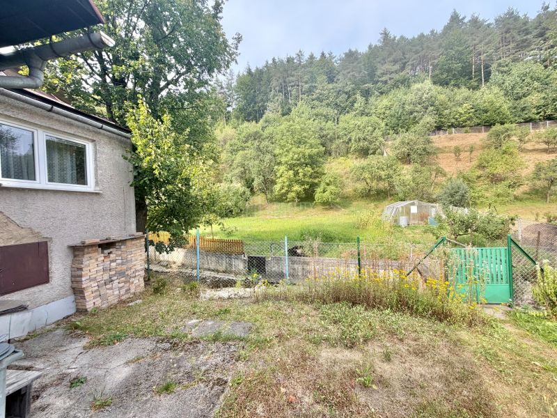A garden at a family house in Ochodnica on Ochodnicka Street, surrounded by trees and greenery.