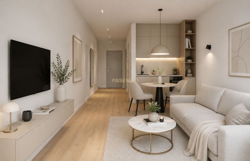 Living room in a studio apartment with wood-patterned flooring and neutral colors.