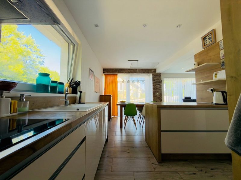 A kitchen with wooden decor and a dining table in a family house.