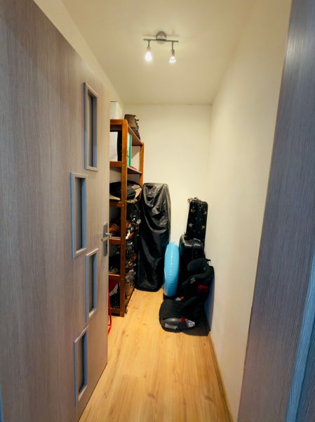 Storage space in a family house with shelves and a wooden decor floor.
