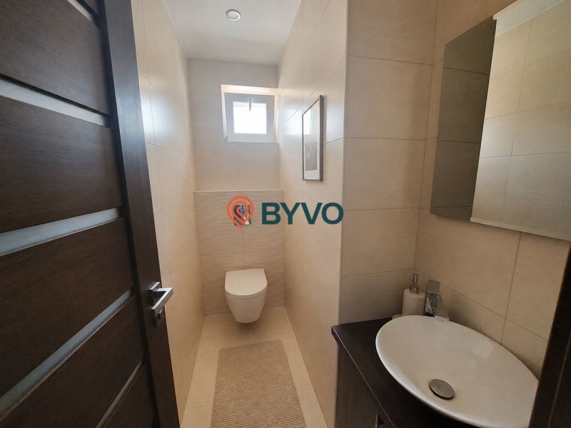 Bathroom in a 4-room apartment with a sink, toilet, and tiles in a subtle design.