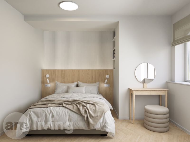 Bright bedroom in a 2-room apartment with a bed and a dressing table, wooden decor flooring.