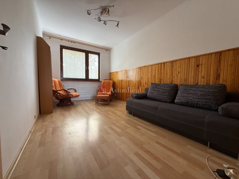 Living room with a sofa set, armchairs, and a wooden decor floor in a 4-room apartment.