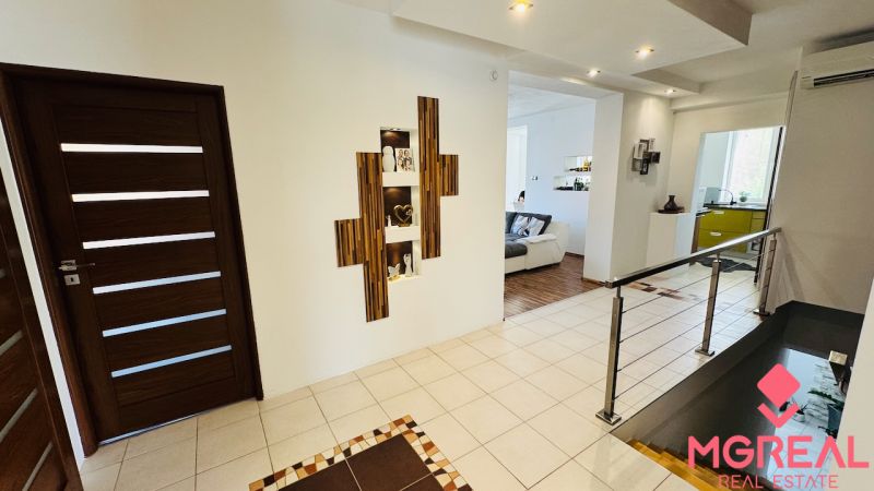 Interior of a family house with a wooden decor floor and decorative niches.