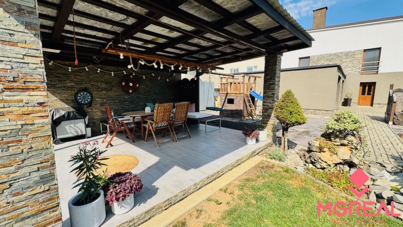 A terrace in a family house in Radobica with seating, a grill, and garden decorations.