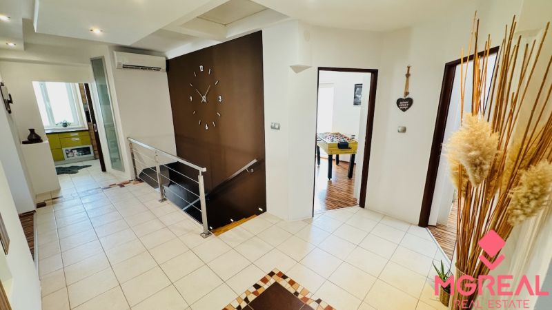 A hallway in a family house with modern decor and a foosball table.