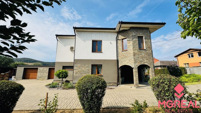 A family house in Radobica with stone cladding and a landscaped garden.