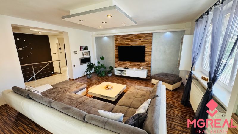 Living room with a comfortable sofa and wooden decor flooring in a family house.