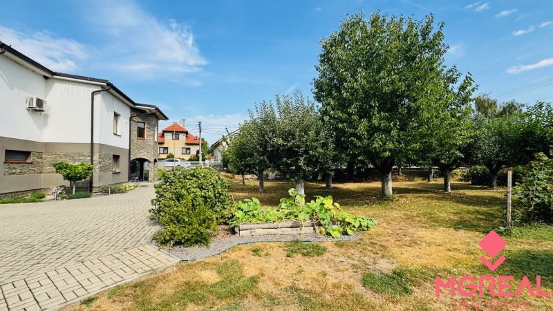 A family house in Radobica surrounded by a well-maintained garden with fruit trees.