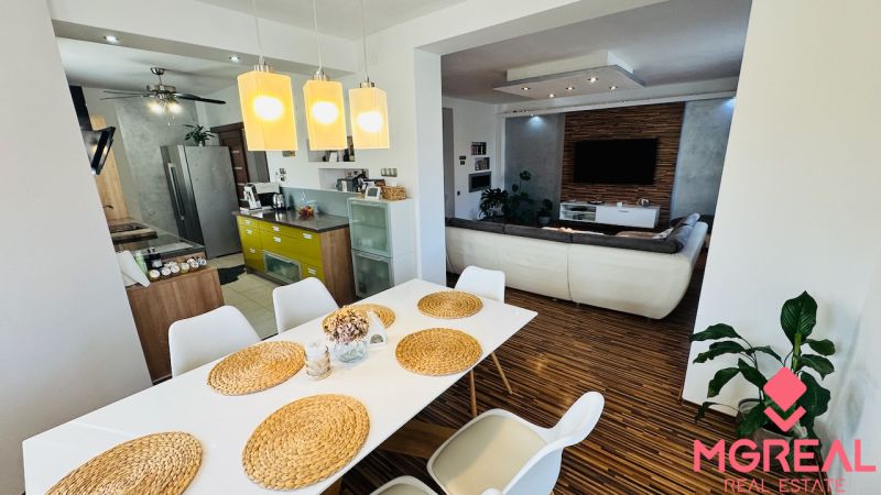 A dining room in a family house with elegant table settings and a wooden decor floor.