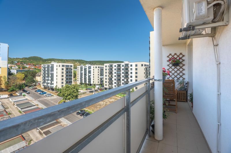 A balcony with a view of residential buildings in Bratislava - Rača on Sadmelijská, 3-room apartment.
