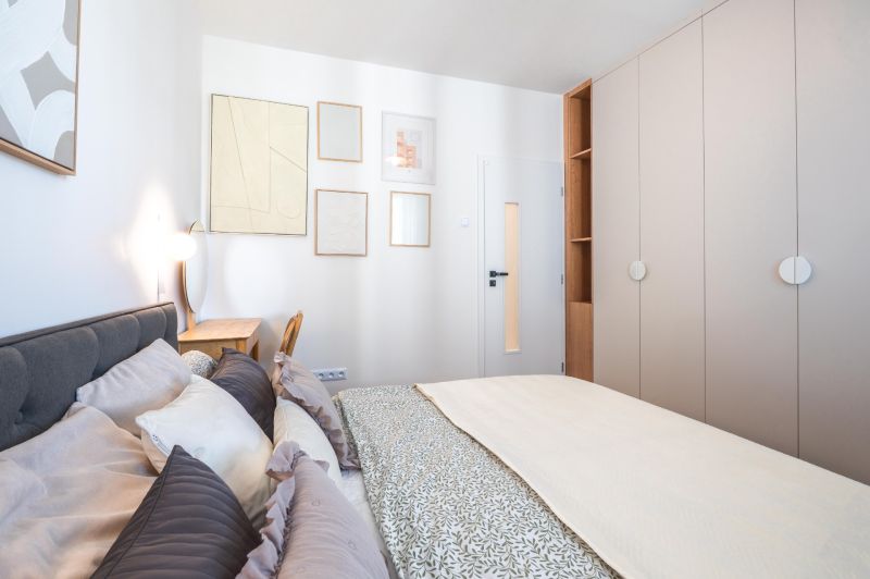 Bedroom with a built-in wardrobe, bed, and decor in a 3-room apartment.