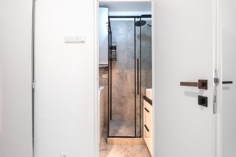 Bathroom with a glass shower enclosure and a sink in a 3-room apartment.