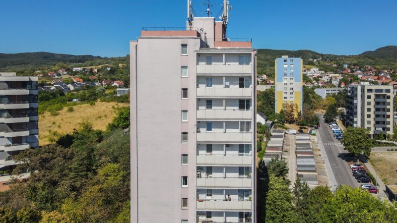 High-rise building on Sadmelijska Street in Bratislava - Rača, surrounded by nature and development.