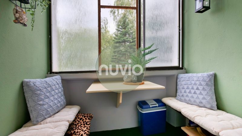 Cozy balcony with cushions and a table in a 2-room apartment.