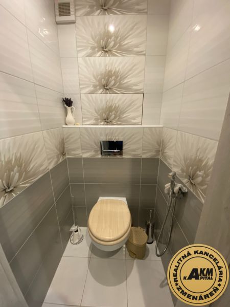 Bathroom in a 2-room apartment with ceramic tiles and a toilet.