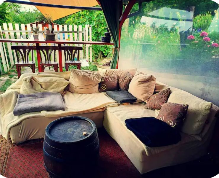 In Piešťany, there is a comfortable seating area with cushions and a wooden table by the family house.