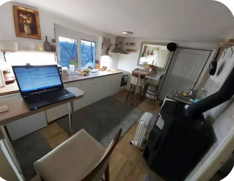 Kitchen in a family house with a work desk, kitchen furniture, and a stove.