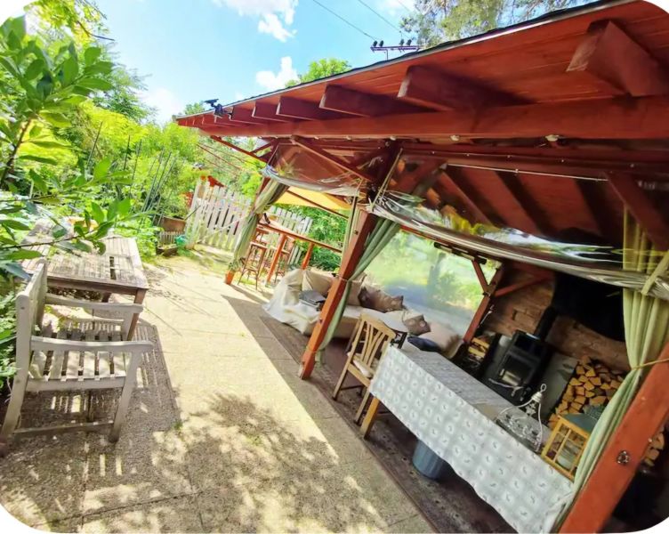 A gazebo at a family house in Piešťany with wooden furniture and a garden seating area.
