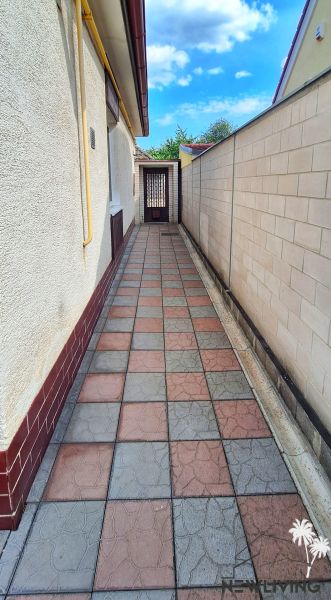 A narrow passage with paving next to a family house on Bodona Street in Piešťany.