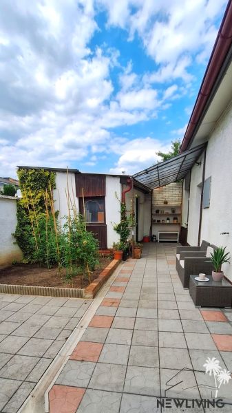 In Piešťany on Bodona Street, there is a courtyard of a family house with a terrace and plants.
