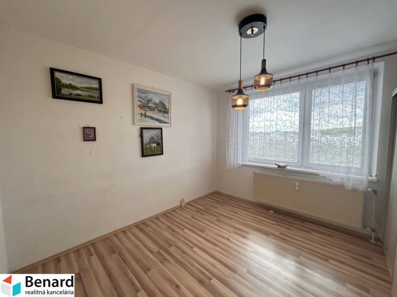 A room with a wooden floor decor, paintings on the wall, curtains, lights, 3-room apartment.