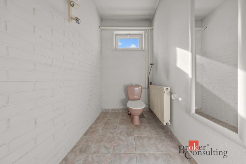 A bathroom with light walls and tiles in a family house.