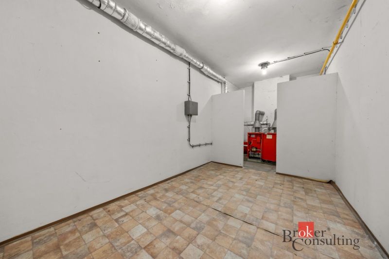 Technical room with a boiler in a family house. Floor with tile decor.