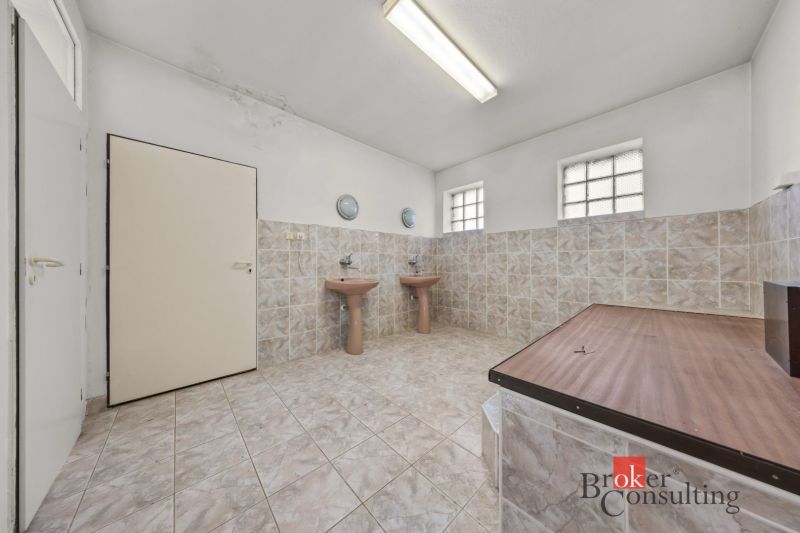 A bathroom in a family house with two sinks and tiles.