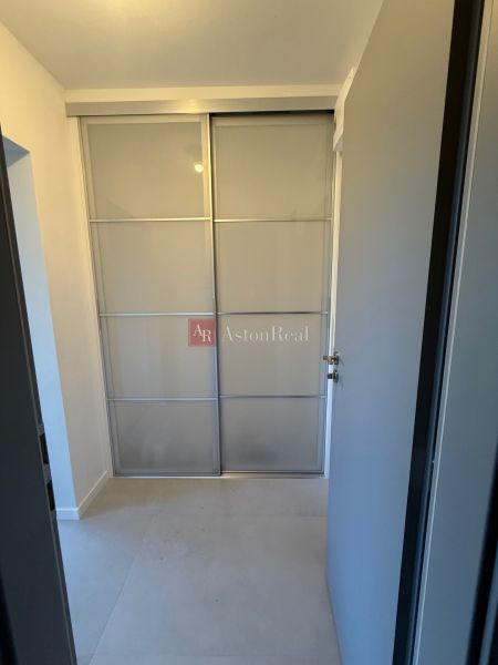 Sliding doors for a built-in wardrobe in a studio apartment.