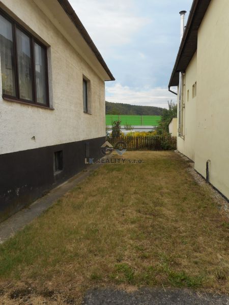 A family house in Trenčín with a narrow garden between two buildings.