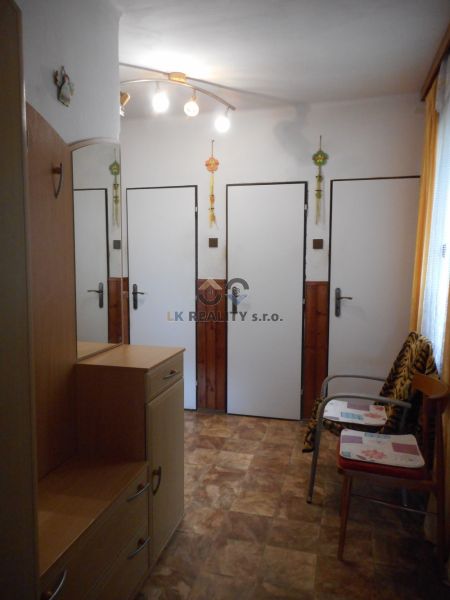 Interior of a family house with a wooden decor floor and simple furniture.