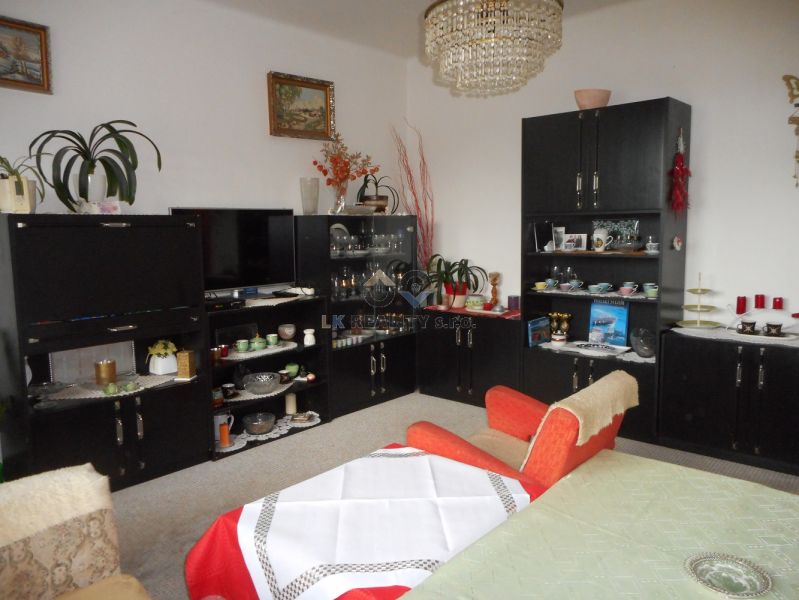 Living room in a family house with stylish furniture and decorations, a chandelier dominates the room.