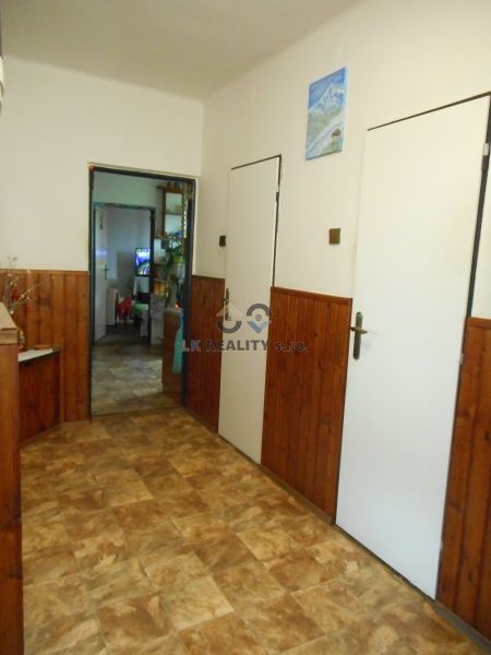 A classic hallway in a family house with a floor featuring a wooden decor pattern.
