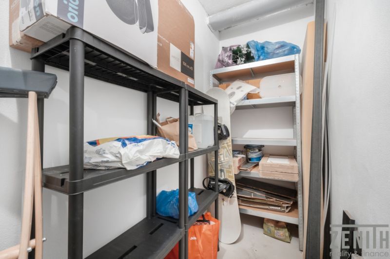 Storage space with shelves and various items in a 2-room apartment.