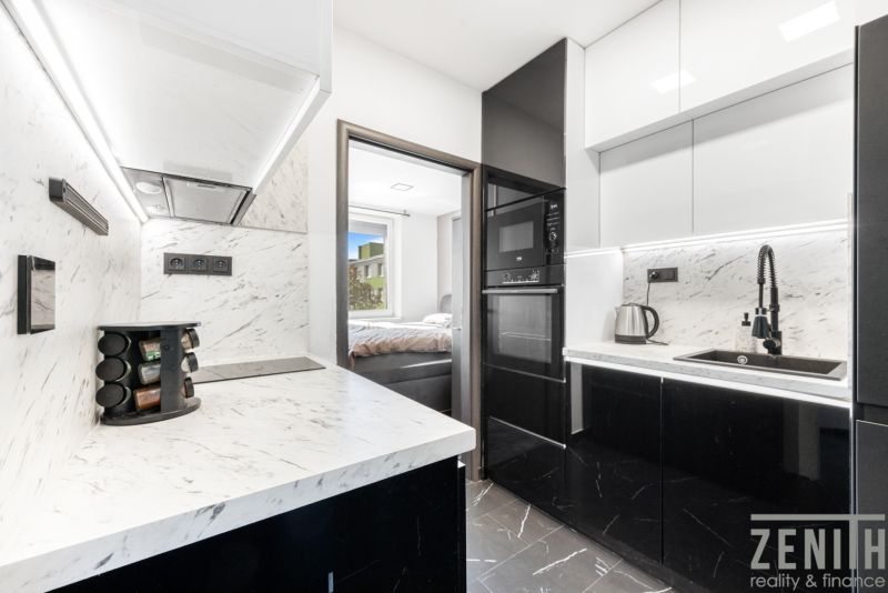 A 2-room apartment kitchen with marble countertops and modern appliances.