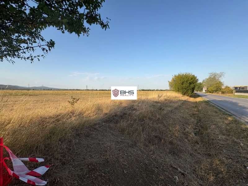 Commercial land on Šenkvická Road in Pezinok with an extensive meadow and sky.