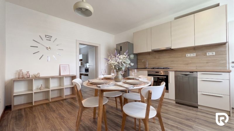 Kitchen with dining table, wooden decor flooring, 2-room apartment, elegant interior.