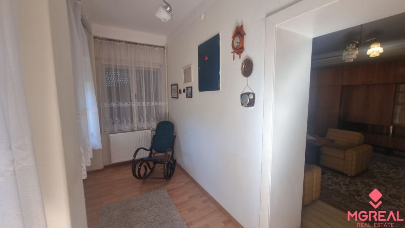 Interior of a family house with a wooden decor floor and a rocking chair.