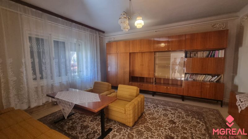 Living room in a family house with retro furniture, armchairs, and curtains.