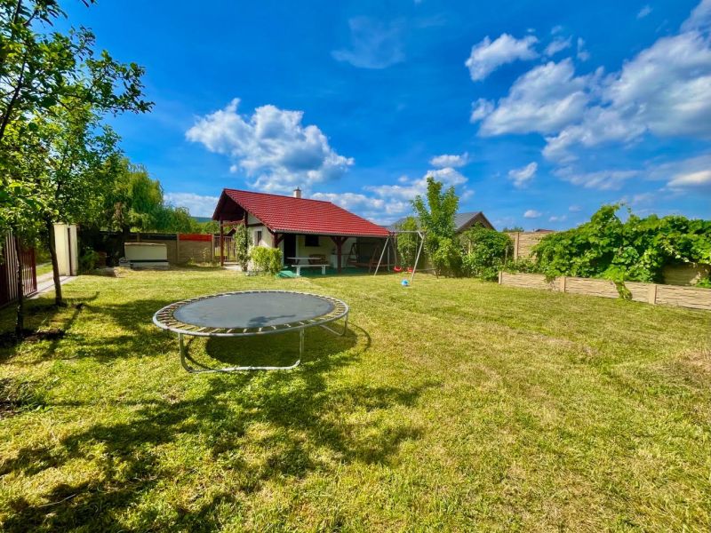 Gardens in Bratislava – Rača at Žabí majer with a trampoline and a gazebo under the blue sky.