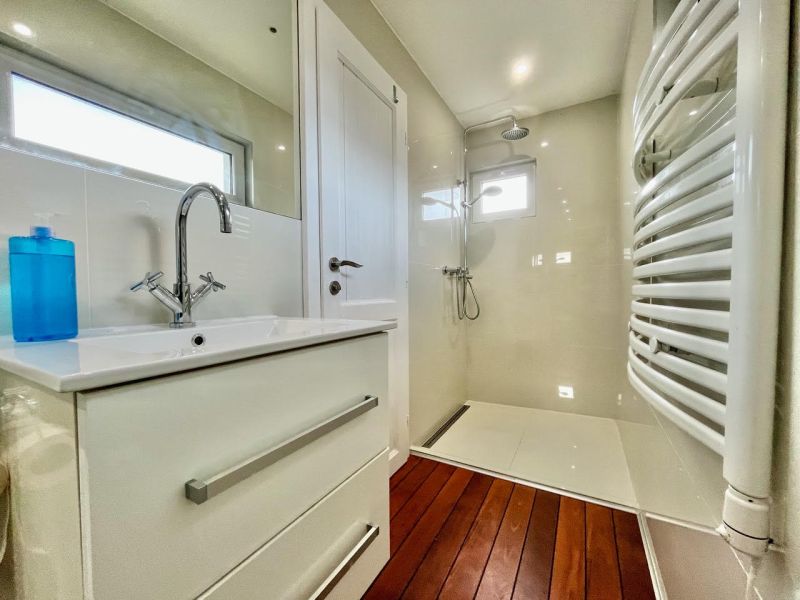 Bathroom with a shower and a wooden decor floor in the Garden area.