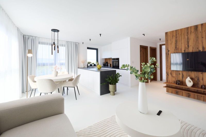 The living room of a 4-room apartment with an elegant table, kitchen, and a television on a wooden wall.