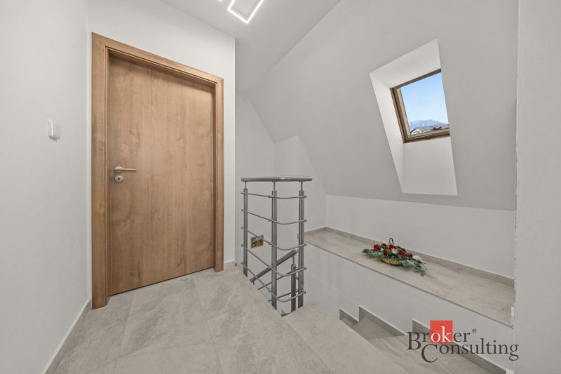 Interior of a 4-room apartment with wooden doors, tiles, and a skylight.