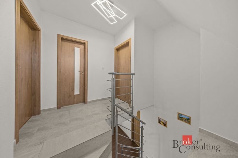 A staircase with wooden doors and railing in the interior of a 4-room apartment.