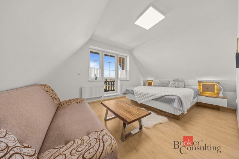 Bright bedroom in a 4-room apartment with wood-decor flooring and a balcony.