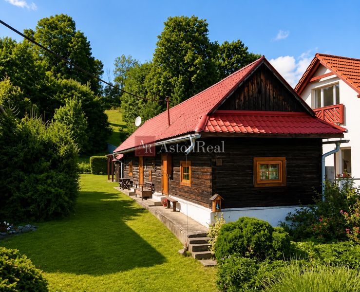 A cottage in Beňadiková with a red roof surrounded by greenery and trees.